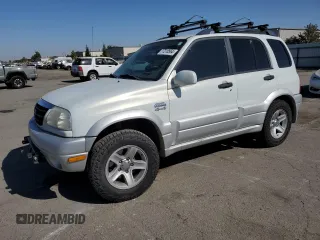 2003 Suzuki Grand Vitara z VIN JS3TD62V734102584, wystawiony jako Copart lot #77210564 z przebiegiem 148 477 mil mil oraz Szkody całkowita. Historia ofert i sprzedaży dostępna na DreamBid. Obrazek 1.