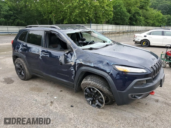 2015 Jeep Cherokee Trailhawk with VIN 1C4PJMBB8FW740452, listed as a Copart auction lot 63023715 with 96,236 mi miles and Salvage title. Bid and sale history available at DreamBid. Image 4.