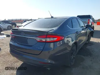 2018 Ford Fusion SE z VIN 3FA6P0LU8JR116073, wystawiony jako IAAI lot #41773037 z przebiegiem 100 864 mil mil oraz . Historia ofert i sprzedaży dostępna na DreamBid. Obrazek 4.
