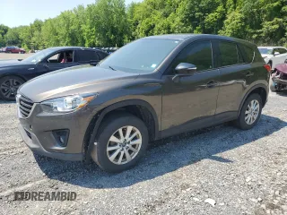 2016 Mazda CX-5 Sport z VIN JM3KE4BY1G0814101, wystawiony jako Copart lot #59000885 z przebiegiem 136 668 mil mil oraz Szkoda całkowita • Salvage title. Historia ofert i sprzedaży dostępna na DreamBid. Obrazek 1.