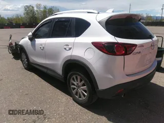 2014 Mazda CX-5 Touring with VIN JM3KE2CY7E0364311, listed as a IAAI auction lot 42108176 with 90,506 mi miles and . Bid and sale history available at DreamBid. Image 3.