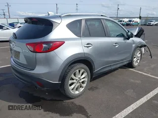 2014 Mazda CX-5 Grand Touring with VIN JM3KE4DY9E0375014, listed as a IAAI auction lot 42000382 with 110,584 mi miles and . Bid and sale history available at DreamBid. Image 4.