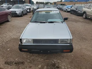 1987 Nissan Sentra z VIN JN1PB2210HU557007, wystawiony jako Copart lot #68174784 z przebiegiem 150 316 mil mil oraz Tytuł czysty. Historia ofert i sprzedaży dostępna na DreamBid. Obrazek 5.