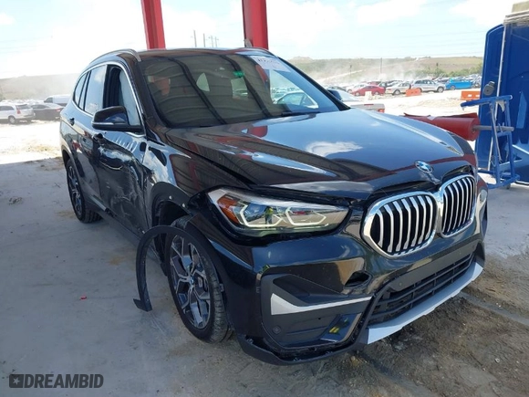 2021 BMW X1 sDrive28i with VIN WBXJG7C02M5S59010, listed as a IAAI auction lot 41933532 with 49,207 mi miles. Bid and sale history available at carsss.com. Image 1.