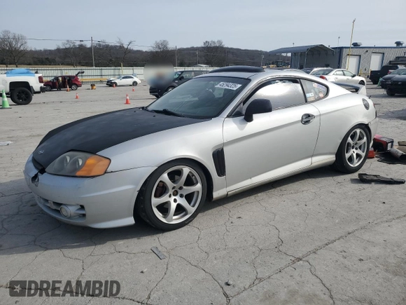 2003 Hyundai Tiburon GT z VIN KMHHN65F13U102985, wystawiony jako Copart lot #45294325 z przebiegiem 326 919 mil mil oraz Szkoda całkowita • Salvage title. Historia ofert i sprzedaży dostępna na DreamBid. Obrazek 1.