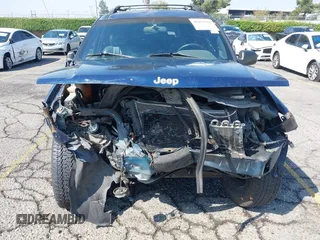 1999 Jeep Grand Cherokee Laredo z VIN 1J4G258S1XC787295, wystawiony jako IAAI lot #40450680 z przebiegiem Nie podano mil oraz . Historia ofert i sprzedaży dostępna na DreamBid. Obrazek 6.