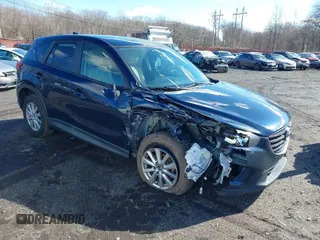 2016 Mazda CX-5 Touring z VIN JM3KE4CY6G0717393, wystawiony jako IAAI lot #41596084 z przebiegiem 150 774 mil mil oraz . Historia ofert i sprzedaży dostępna na DreamBid. Obrazek 1.
