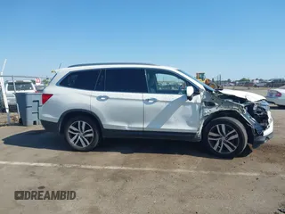 2018 Honda Pilot Touring with VIN 5FNYF6H95JB019122, listed as a IAAI auction lot 42439283 with 128,848 mi miles and . Bid and sale history available at DreamBid. Image 13.