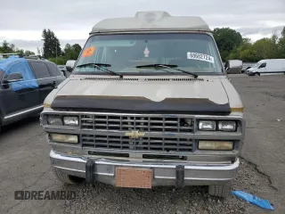 1992 Chevrolet Chevy Van z VIN 1GBEG25K2N7130047, wystawiony jako Copart lot #68682724 z przebiegiem 143 585 mil mil oraz Szkody całkowita. Historia ofert i sprzedaży dostępna na DreamBid. Obrazek 5.