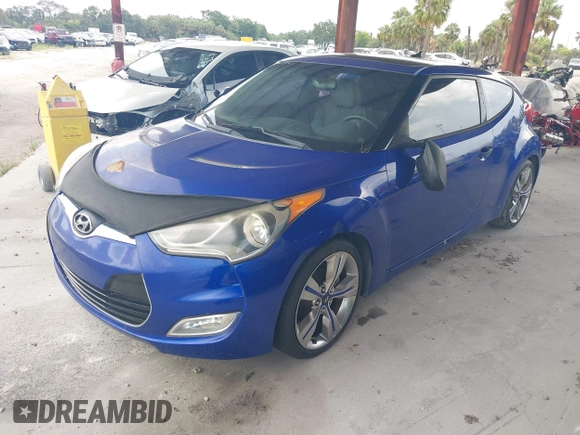 2012 Hyundai Veloster w/Gray Int z VIN KMHTC6AD0CU034683, wystawiony jako IAAI lot #42395112 z przebiegiem 134 388 mil mil oraz . Historia ofert i sprzedaży dostępna na DreamBid. Obrazek 2.