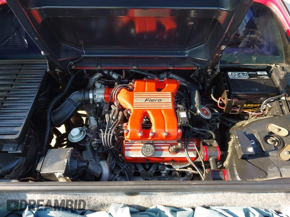 1986 Pontiac Fiero z VIN 1G2PG9791GP267415, wystawiony jako IAAI lot #42461769 z przebiegiem Nie podano mil oraz . Historia ofert i sprzedaży dostępna na DreamBid. Obrazek 10.