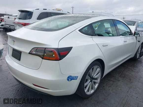 2020 Tesla Model 3 Standard Range Plus with VIN 5YJ3E1EA0LF741311, listed as a IAAI auction lot 41581931 with 43,284 mi miles. Bid and sale history available at carsss.com. Image 4.