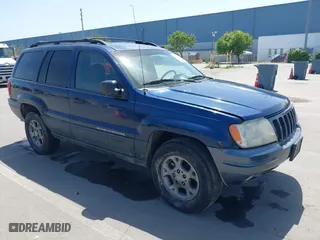 1999 Jeep Grand Cherokee Laredo with VIN 1J4GW58S7XC791856, listed as a IAAI auction lot 42111507 with 203,392 mi miles. Bid and sale history available at carsss.com. Image 1.