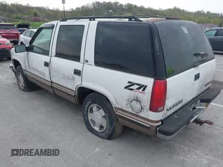 1997 GMC Yukon with VIN 1GKEK13R2VJ739795, listed as a IAAI auction lot 42011678 with 185,306 mi miles. Bid and sale history available at carsss.com. Image 3.