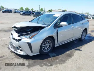 2021 Toyota Prius L Eco with VIN JTDKAMFUXM3144991, listed as a IAAI auction lot 42147025 with 106,466 mi miles and . Bid and sale history available at DreamBid. Image 2.