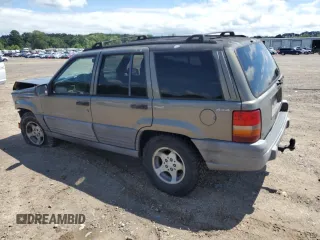 1997 Jeep Grand Cherokee Laredo with VIN 1J4GZ58S7VC505069, listed as a Copart auction lot 63255945 with 127,552 mi miles and Salvage title. Bid and sale history available at DreamBid. Image 2.
