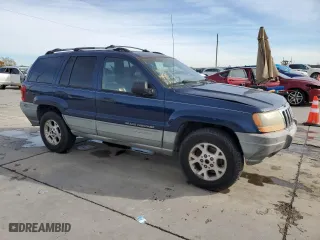 1999 Jeep Grand Cherokee Laredo with VIN 1J4GW58S0XC653687, listed as a Copart auction lot 81166844 with 252,330 mi miles and Salvage Title. Bid and sale history available at carsss.com. Image 4.