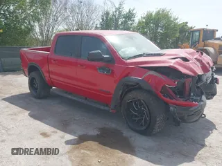 2021 Ram 1500 Rebel z VIN 1C6SRFLMXMN730577, wystawiony jako IAAI lot #41782120 z przebiegiem 63 033 mil mil oraz . Historia ofert i sprzedaży dostępna na DreamBid. Obrazek 1.