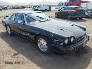 1989 Jaguar XJS with VIN SAJNA5840KC151334, listed as a IAAI auction lot 41702577 with 113,000 mi miles and . Bid and sale history available at DreamBid. Image 1.