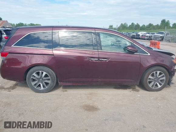 2014 Honda Odyssey Touring with VIN 5FNRL5H90EB120999, listed as a IAAI auction lot 42541370 with 96,454 mi miles and . Bid and sale history available at DreamBid. Image 14.