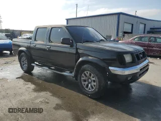 2000 Nissan Frontier XE with VIN 1N6ED27T7YC300373, listed as a Copart auction lot 55829535 with 301,305 mi miles and Salvage title. Bid and sale history available at DreamBid. Image 4.