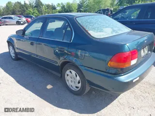 1997 Honda Civic LX with VIN JHMEJ6678VS032473, listed as a IAAI auction lot 42110249 with 257,328 mi miles. Bid and sale history available at carsss.com. Image 3.