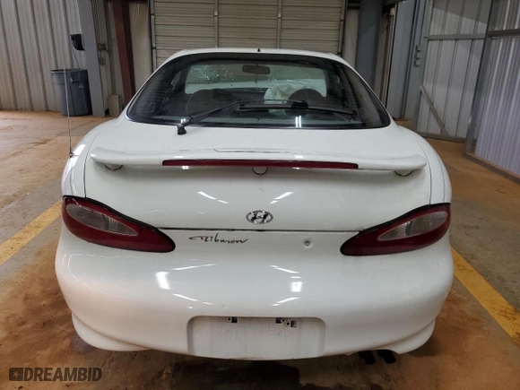1997 Hyundai Tiburon with VIN KMHJG24M6VU052589, listed as a Copart auction lot 45118235 with 90,609 mi miles and Salvage Title. Bid and sale history available at carsss.com. Image 6.
