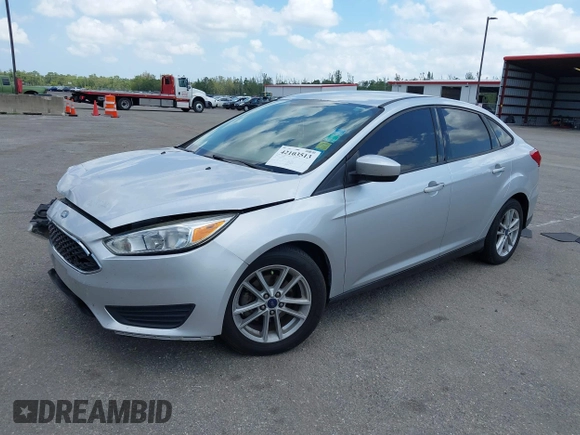 2018 Ford Focus SE z VIN 1FADP3FE9JL241661, wystawiony jako IAAI lot #42103513 z przebiegiem 117 003 mil mil oraz . Historia ofert i sprzedaży dostępna na DreamBid. Obrazek 17.