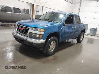 2011 GMC Canyon SLT with VIN 1GTH6NFP8B8115436, listed as a IAAI auction lot 41676023 with 148,478 mi miles. Bid and sale history available at carsss.com. Image 2.