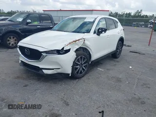 2018 Mazda CX-5 Touring z VIN JM3KFACM6J1419663, wystawiony jako IAAI lot #41879677 z przebiegiem 115 224 mil mil oraz . Historia ofert i sprzedaży dostępna na DreamBid. Obrazek 2.