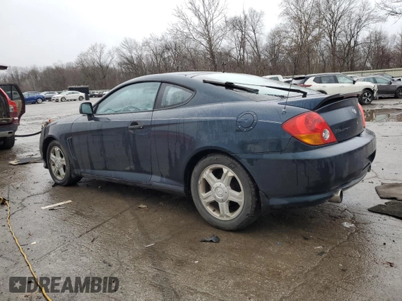 2003 Hyundai Tiburon GT z VIN KMHHN65F13U068658, wystawiony jako Copart lot #81799404 z przebiegiem 163 148 mil mil oraz Szkoda całkowita • Salvage title. Historia ofert i sprzedaży dostępna na DreamBid. Obrazek 2.