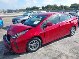 2021 Toyota Prius L Eco with VIN JTDKAMFU4M3145215, listed as a IAAI auction lot 41926274 with 74,220 mi miles. Bid and sale history available at carsss.com. Image 2.