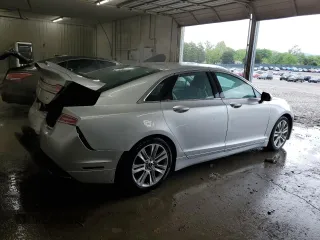 2015 Lincoln MKZ z VIN 3LN6L2GK4FR613117, wystawiony jako Copart lot #54141735 z przebiegiem 129 072 mil mil oraz Szkoda całkowita • Salvage title. Historia ofert i sprzedaży dostępna na DreamBid. Obrazek 3.