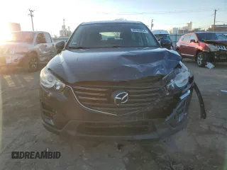 2016 Mazda CX-5 Sport with VIN JM3KE2BY9G0771969, listed as a Copart auction lot 80966064 with 99,348 mi miles and Salvage title. Bid and sale history available at DreamBid. Image 5.