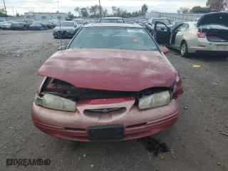 1996 Ford Thunderbird LX with VIN 1FALP62W7TH135632, listed as a Copart auction lot 77134024 with 128,931 mi miles and Salvage Title. Bid and sale history available at carsss.com. Image 5.