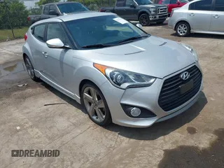 2013 Hyundai Veloster Turbo z VIN KMHTC6AE0DU136253, wystawiony jako IAAI lot #42173755 z przebiegiem 100 414 mil mil oraz . Historia ofert i sprzedaży dostępna na DreamBid. Obrazek 1.