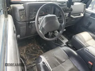 1999 Jeep Wrangler SE z VIN 1J4FY29P0XP479580, wystawiony jako Copart lot #63075455 z przebiegiem 160 986 mil mil oraz Szkoda całkowita • Salvage title. Historia ofert i sprzedaży dostępna na DreamBid. Obrazek 8.