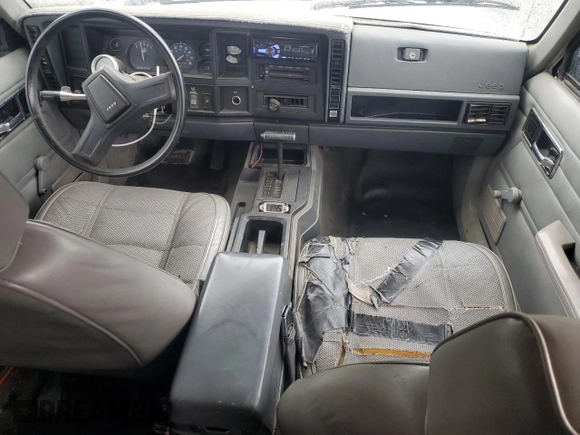 1989 Jeep Cherokee z VIN 1J4FT28LXKL601505, wystawiony jako Copart lot #49312265 z przebiegiem 264 769 mil mil oraz Szkoda całkowita • Salvage title. Historia ofert i sprzedaży dostępna na DreamBid. Obrazek 8.