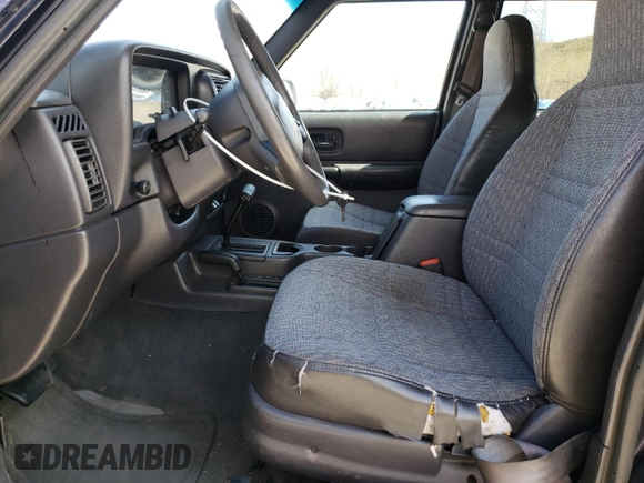 1999 Jeep Cherokee Sport z VIN 1J4FF68S8XL604061, wystawiony jako Copart lot #53175345 z przebiegiem 206 698 mil mil oraz Nie do naprawy • Non repairable. Historia ofert i sprzedaży dostępna na DreamBid. Obrazek 7.