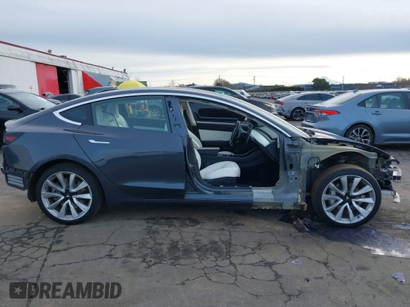 2018 Tesla Model 3 Long Range Battery with VIN 5YJ3E1EB9JF097118, listed as a IAAI auction lot 41619510 with 64,132 mi miles and . Bid and sale history available at DreamBid. Image 14.