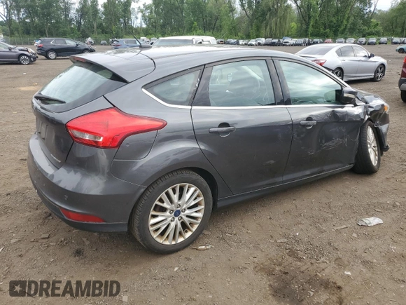 2017 Ford Focus Titanium z VIN 1FADP3N29HL240527, wystawiony jako Copart lot #62891695 z przebiegiem 126 926 mil mil oraz Szkoda całkowita • Salvage title. Historia ofert i sprzedaży dostępna na DreamBid. Obrazek 3.
