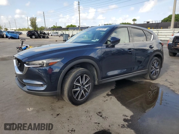 2018 Mazda CX-5 Grand Touring with VIN JM3KFADMXJ1353942, listed as a Copart auction lot 60570835 with 74,400 mi miles and Clean title. Bid and sale history available at DreamBid. Image 1.