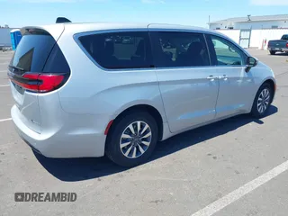 2023 Chrysler Pacifica Hybrid Touring L with VIN 2C4RC1L75PR614460, listed as a IAAI auction lot 42628545 with 68,668 mi miles and . Bid and sale history available at DreamBid. Image 4.