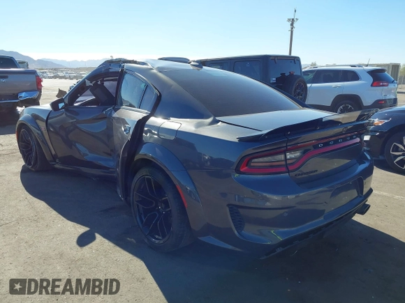 2022 Dodge Charger Scat Pack Widebody with VIN 2C3CDXGJ1NH204130, listed as a IAAI auction lot 41392893 with 9,515 mi miles and . Bid and sale history available at DreamBid. Image 3.
