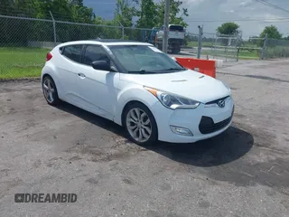2012 Hyundai Veloster w/Gray Int z VIN KMHTC6ADXCU050034, wystawiony jako IAAI lot #42506584 z przebiegiem 142 514 mil mil oraz . Historia ofert i sprzedaży dostępna na DreamBid. Obrazek 1.