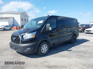 2021 Ford Transit Cargo with VIN 1FTYE1Y85MKA34465, listed as a IAAI auction lot 41736879 with 77,215 mi miles. Bid and sale history available at carsss.com. Image 2.