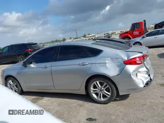 2018 Ford Fusion SE z VIN 3FA6P0LU2JR281231, wystawiony jako IAAI lot #41963083 z przebiegiem 115 434 mil mil oraz . Historia ofert i sprzedaży dostępna na DreamBid. Obrazek 14.