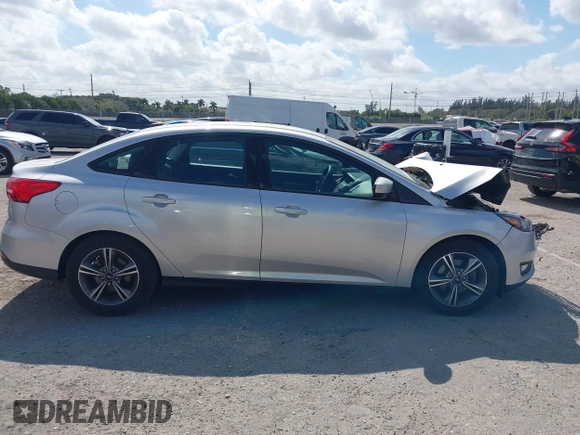 2018 Ford Focus SE z VIN 1FADP3FE3JL220529, wystawiony jako IAAI lot #41564216 z przebiegiem 16 883 mil mil oraz . Historia ofert i sprzedaży dostępna na DreamBid. Obrazek 13.