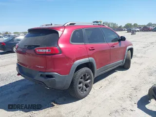 2015 Jeep Cherokee Trailhawk with VIN 1C4PJMBS1FW640483, listed as a IAAI auction lot 41883688 with 103,589 mi miles. Bid and sale history available at carsss.com. Image 4.