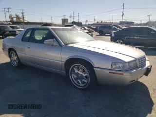 1999 Cadillac Eldorado z VIN 1G6EL12Y0XU604529, wystawiony jako Copart lot #77620004 z przebiegiem 246 032 mil mil oraz Szkoda całkowita • Salvage title. Historia ofert i sprzedaży dostępna na DreamBid. Obrazek 4.